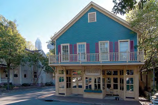 A historic Fourth Ward storefront with the Charlotte skyline rising behind it