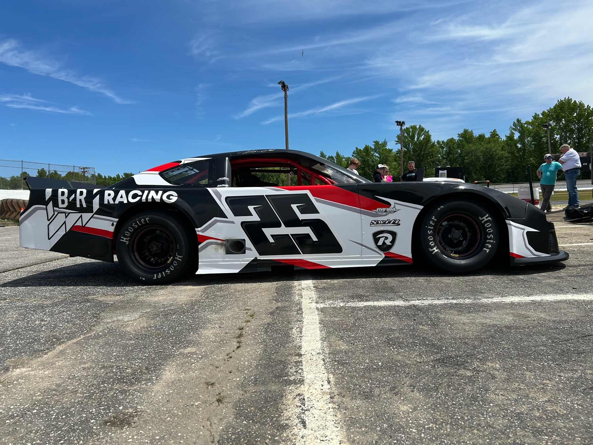 The No. 25 Project Never Lift car at Florence Motor Speedway on practice day. White, black, and red livery with B/R Racing on the quarter panel.
