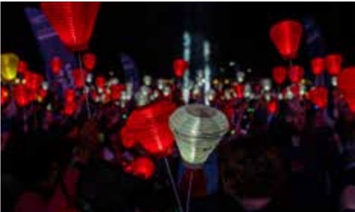 Red and white lanterns glowing in the dark at Light The Night