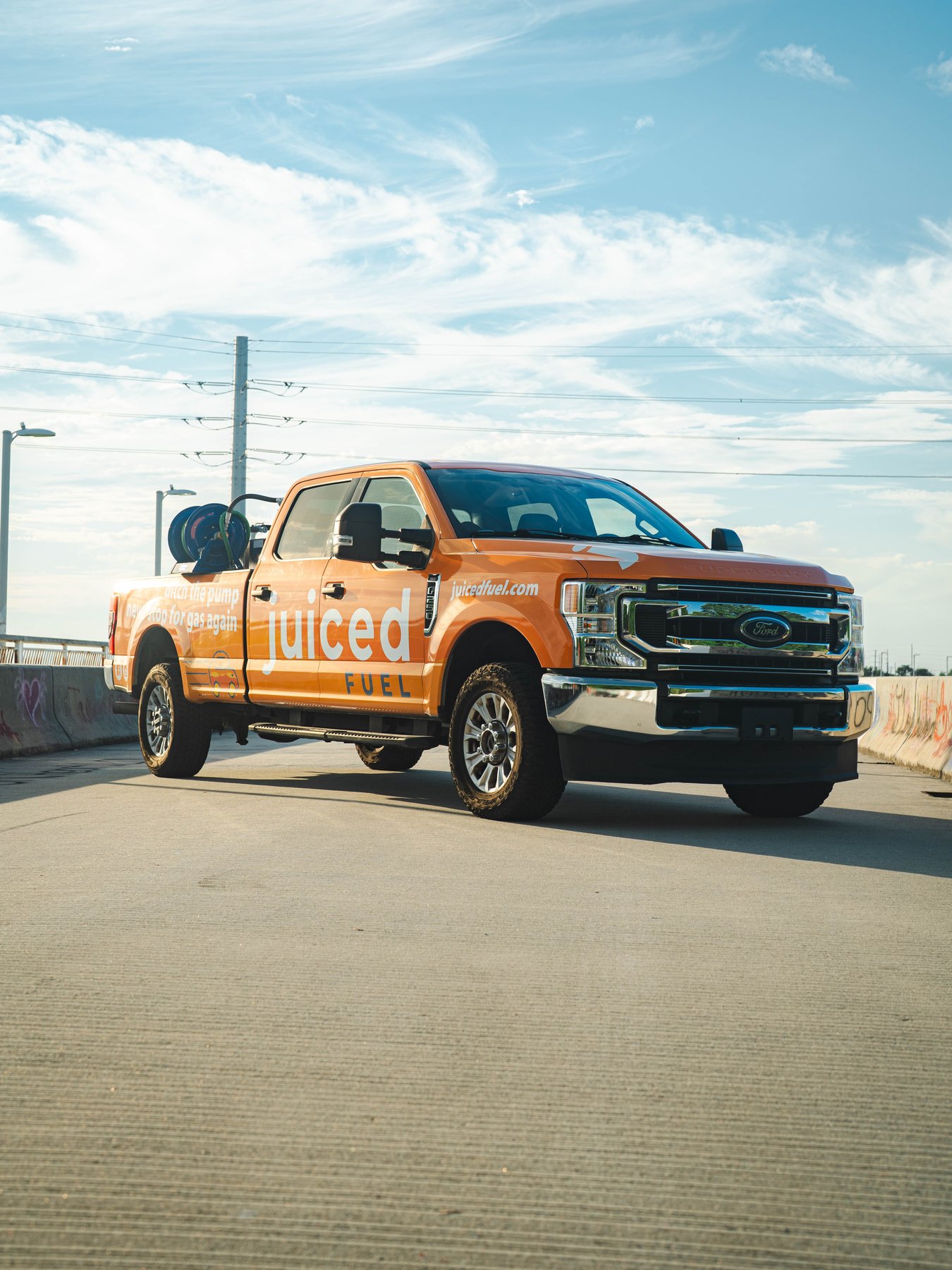 Orange Juiced Fuel pickup truck with a fuel tank in the bed