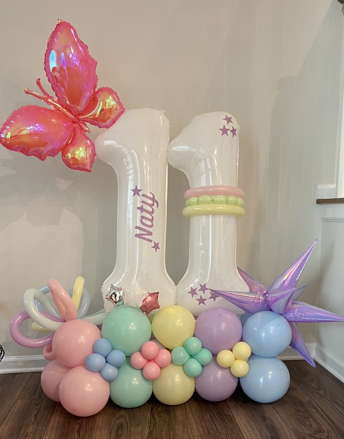Pastel first-birthday balloon display by Vive POP