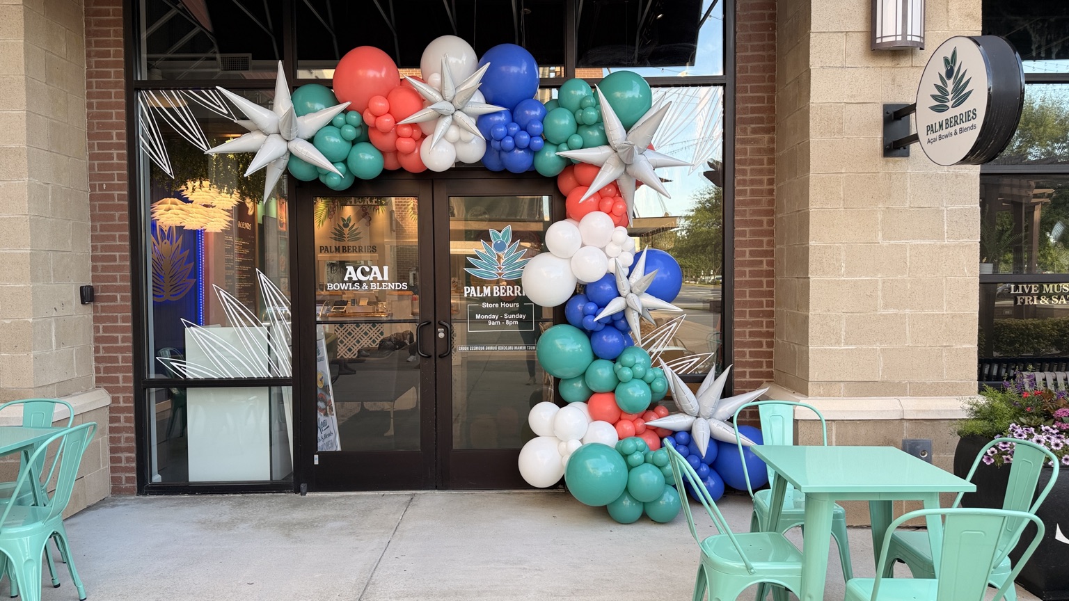 Balloon arch framing the Palm Berries storefront