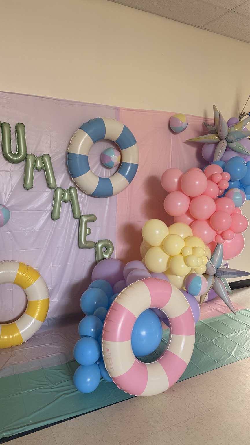 Summer-themed balloon backdrop with pool floats